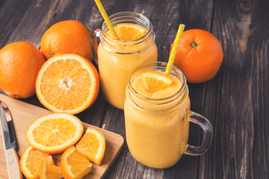 Orange fruit smoothie in the glass jars
